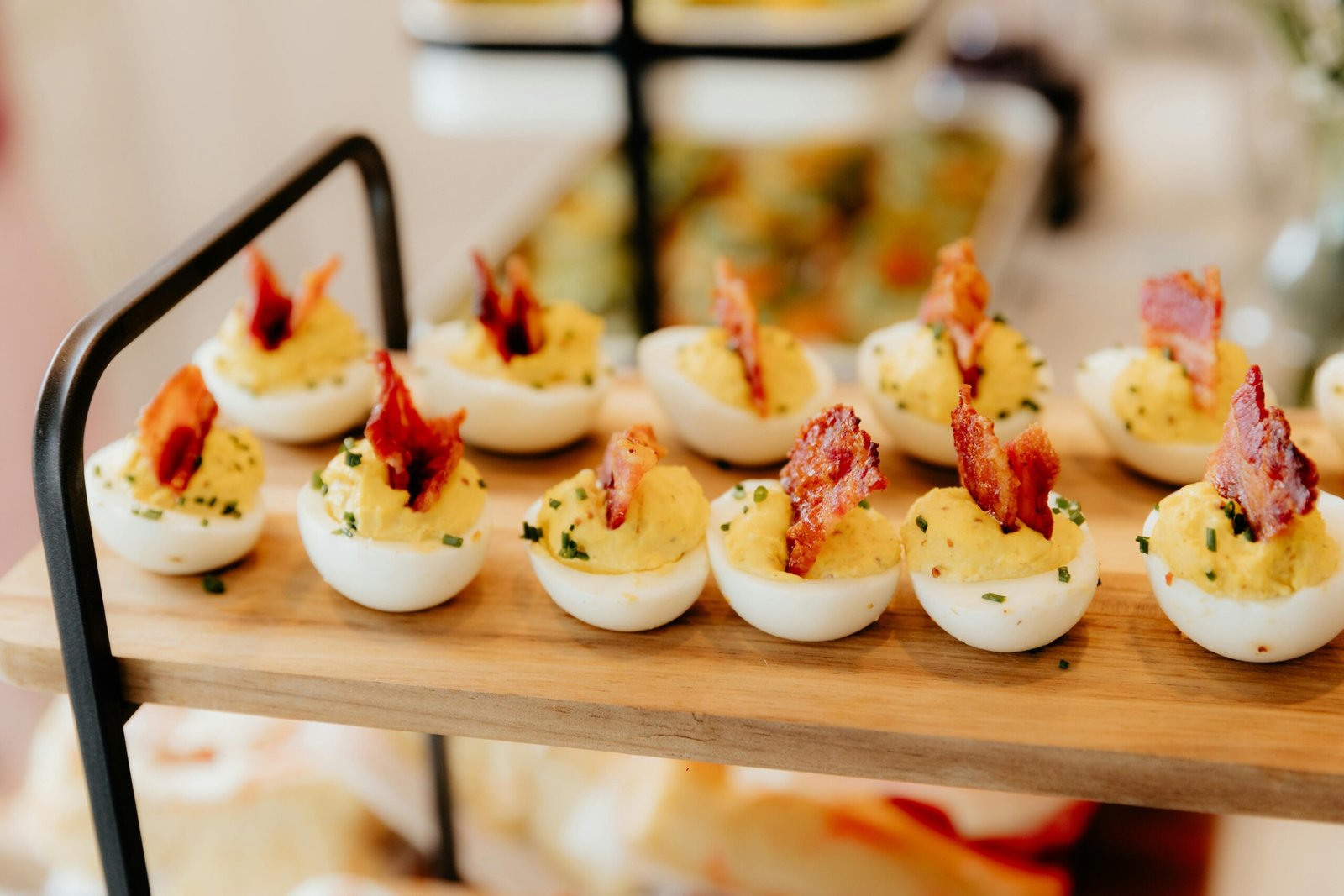 Savory deviled eggs topped with crispy bacon, perfect for party appetizers.
